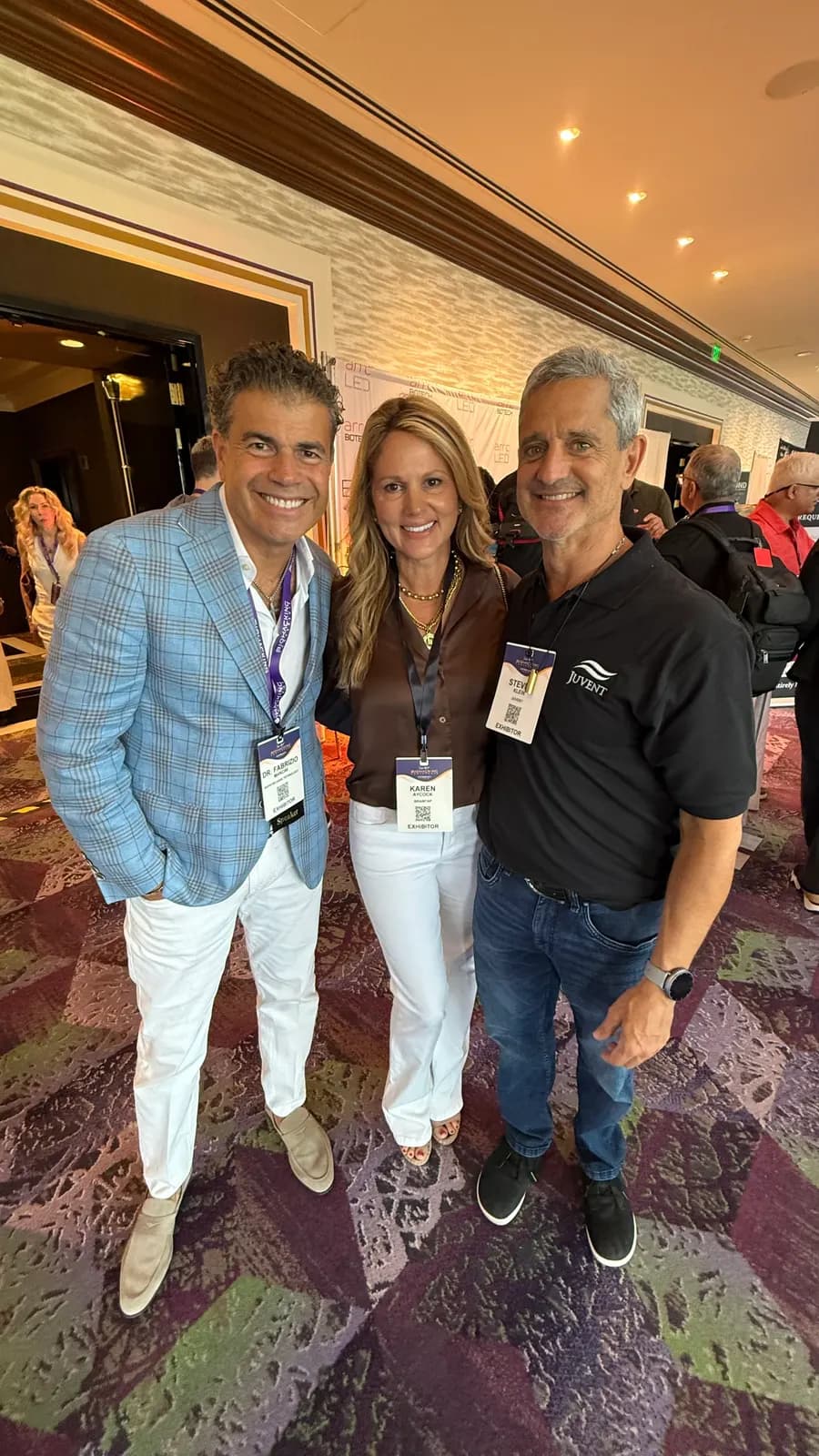 Steven with two friends at an evening event