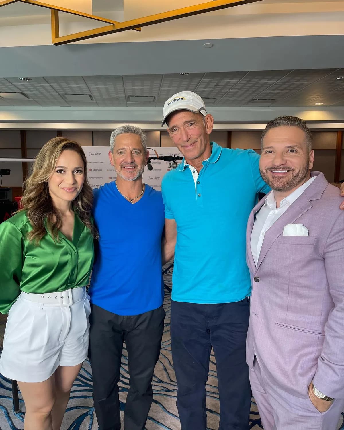 Steven in his electric blue tee with friends at a wellness event